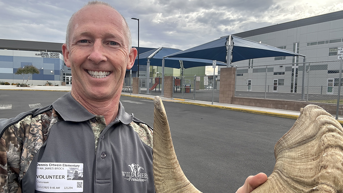 Dr. Ryan Brock in front of the Dennis Ortwen Elementary School with a sheep horn Dr. Ryan Brock in front of the Dennis Ortwen Elementary School with a sheep horn